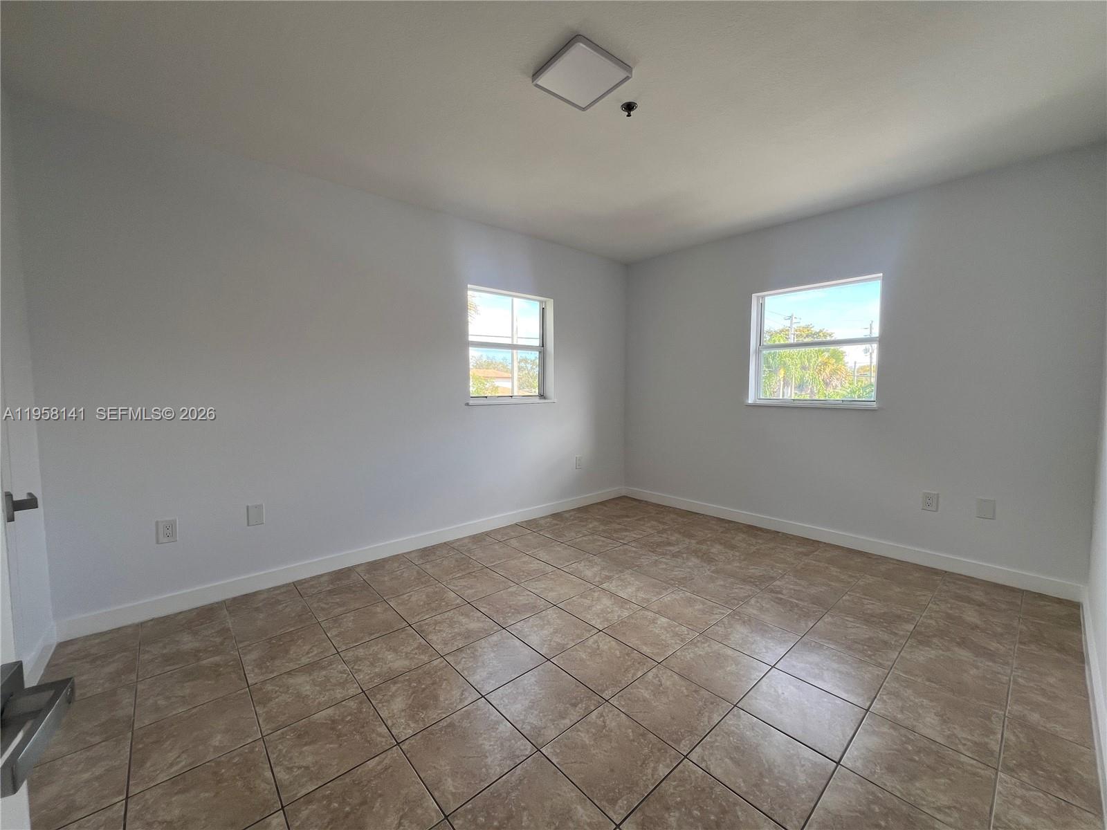 9720 Southwest 184th Street, Unit 210 Cutler Bay, FL 33157 - Photo 8 of 12 a view of empty room with windows
