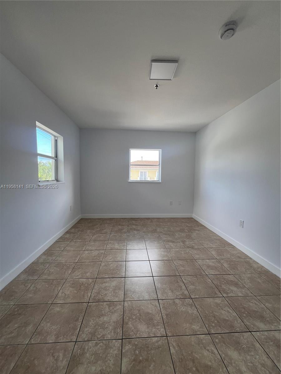 9720 Southwest 184th Street, Unit 210 Cutler Bay, FL 33157 - Photo 9 of 12 a view of an empty room and window