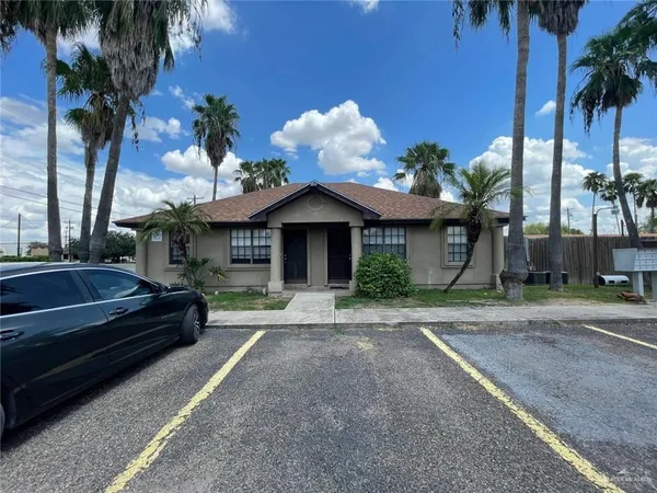 a front view of a house with a yard and a garage