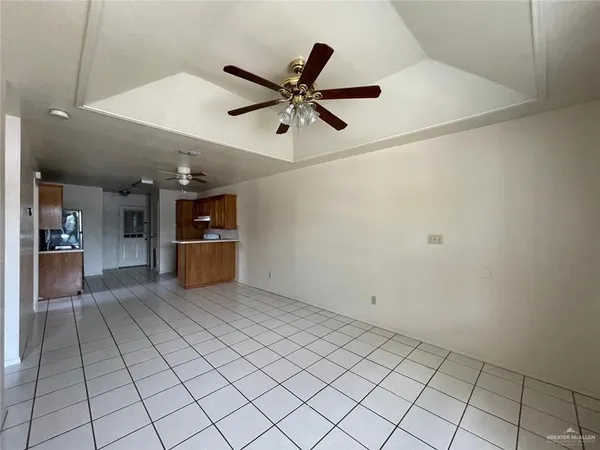 a view of a livingroom with a ceiling fan and wooden floor