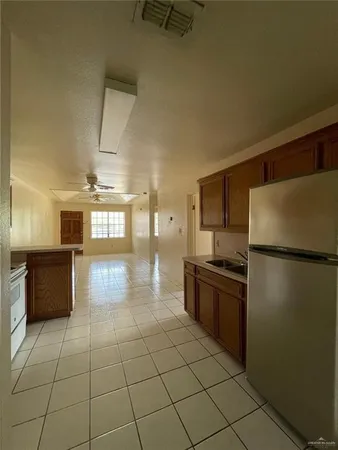 a kitchen with stainless steel appliances granite countertop a refrigerator and a stove
