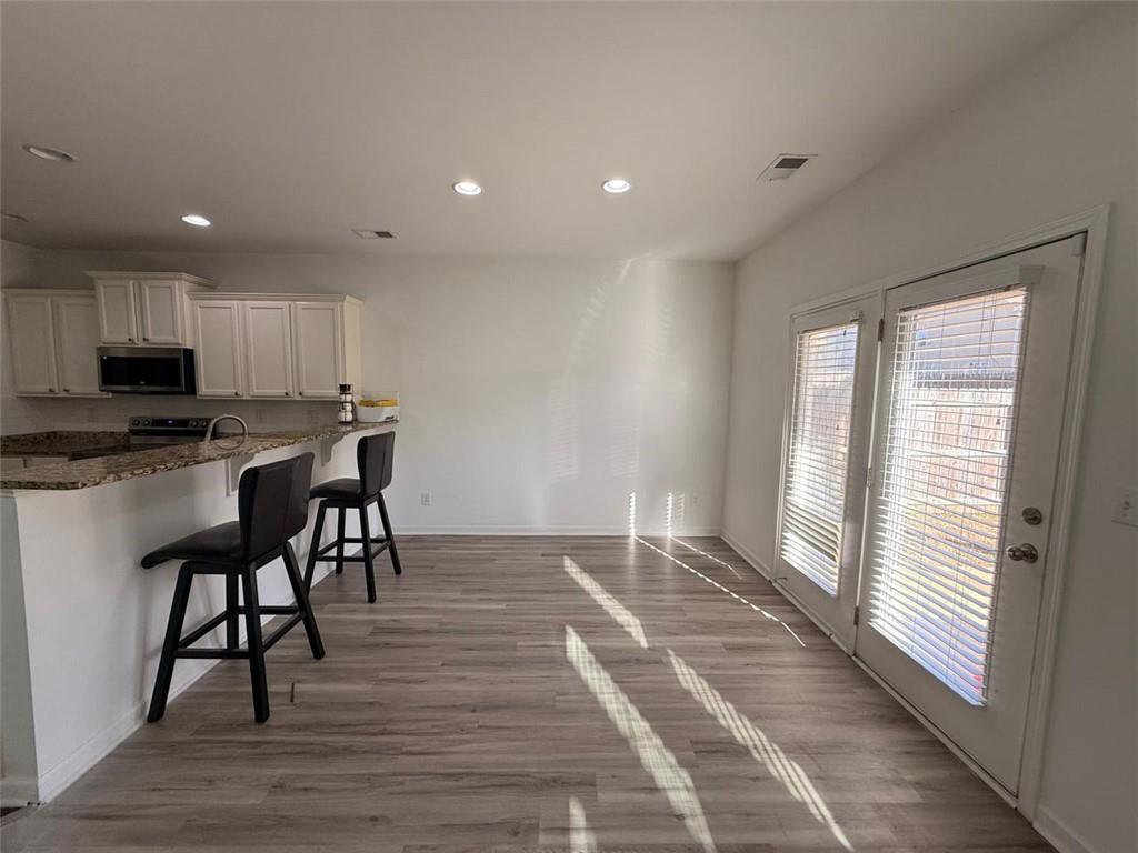 2450 Oakleaf Circle Lithonia, GA 30058 - Photo 11 of 40 a view of kitchen with granite countertop cabinets and wooden floor