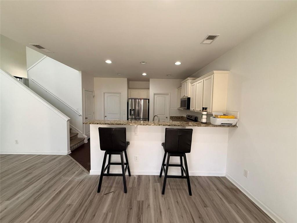 2450 Oakleaf Circle Lithonia, GA 30058 - Photo 12 of 40 a view of kitchen with cabinets and wooden floor