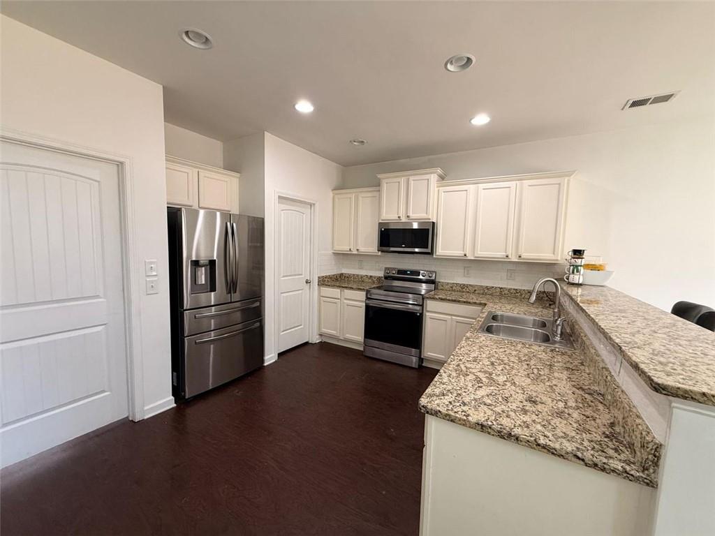 2450 Oakleaf Circle Lithonia, GA 30058 - Photo 13 of 40 a kitchen with a refrigerator a sink and a stove