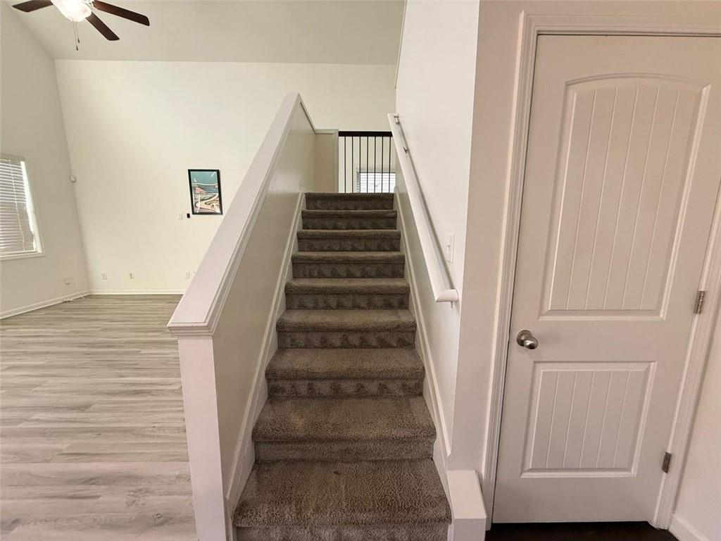 2450 Oakleaf Circle Lithonia, GA 30058 - Photo 23 of 40 a view of staircase with wooden floor and white walls