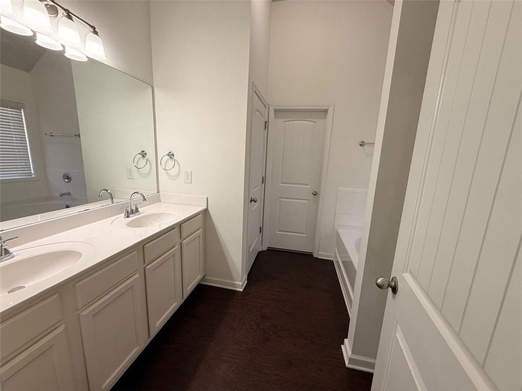 2450 Oakleaf Circle Lithonia, GA 30058 - Photo 29 of 40 a spacious bathroom with a double vanity sink and a mirror