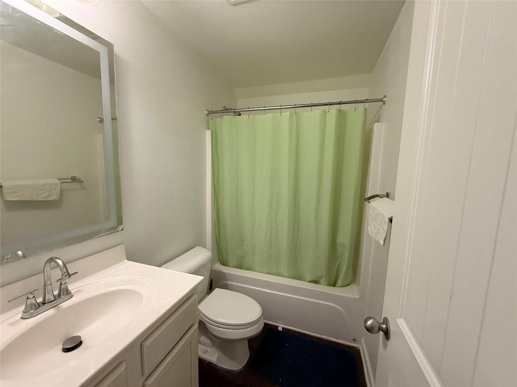 2450 Oakleaf Circle Lithonia, GA 30058 - Photo 34 of 40 a bathroom with a sink a toilet a mirror and shower