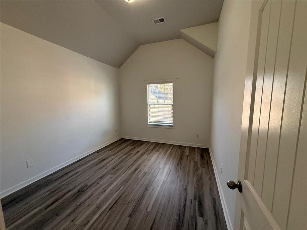 2450 Oakleaf Circle Lithonia, GA 30058 - Photo 36 of 40 a view of an empty room with wooden floor and a window