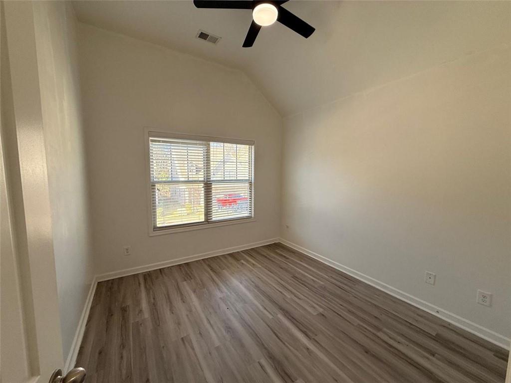 2450 Oakleaf Circle Lithonia, GA 30058 - Photo 37 of 40 wooden floor in an empty room with a window