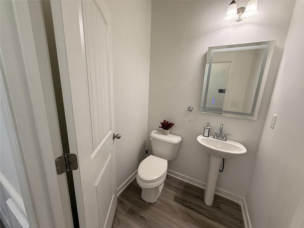 2450 Oakleaf Circle Lithonia, GA 30058 - Photo 7 of 40 a bathroom with a toilet sink and a mirror