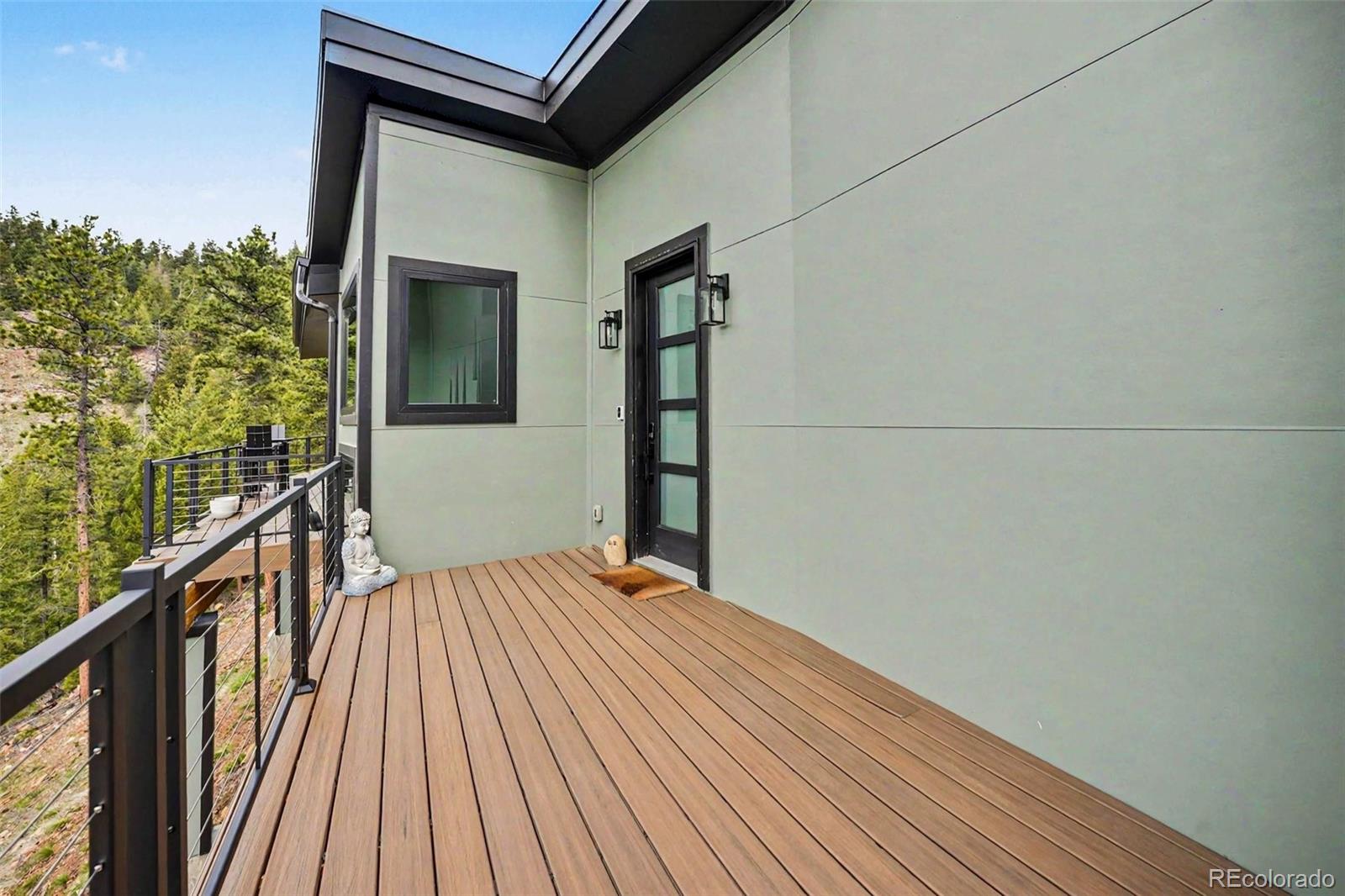 7231 Timber Trail Road Evergreen, CO 80439 - Photo 26 of 35 a view of balcony with wooden floor and fence