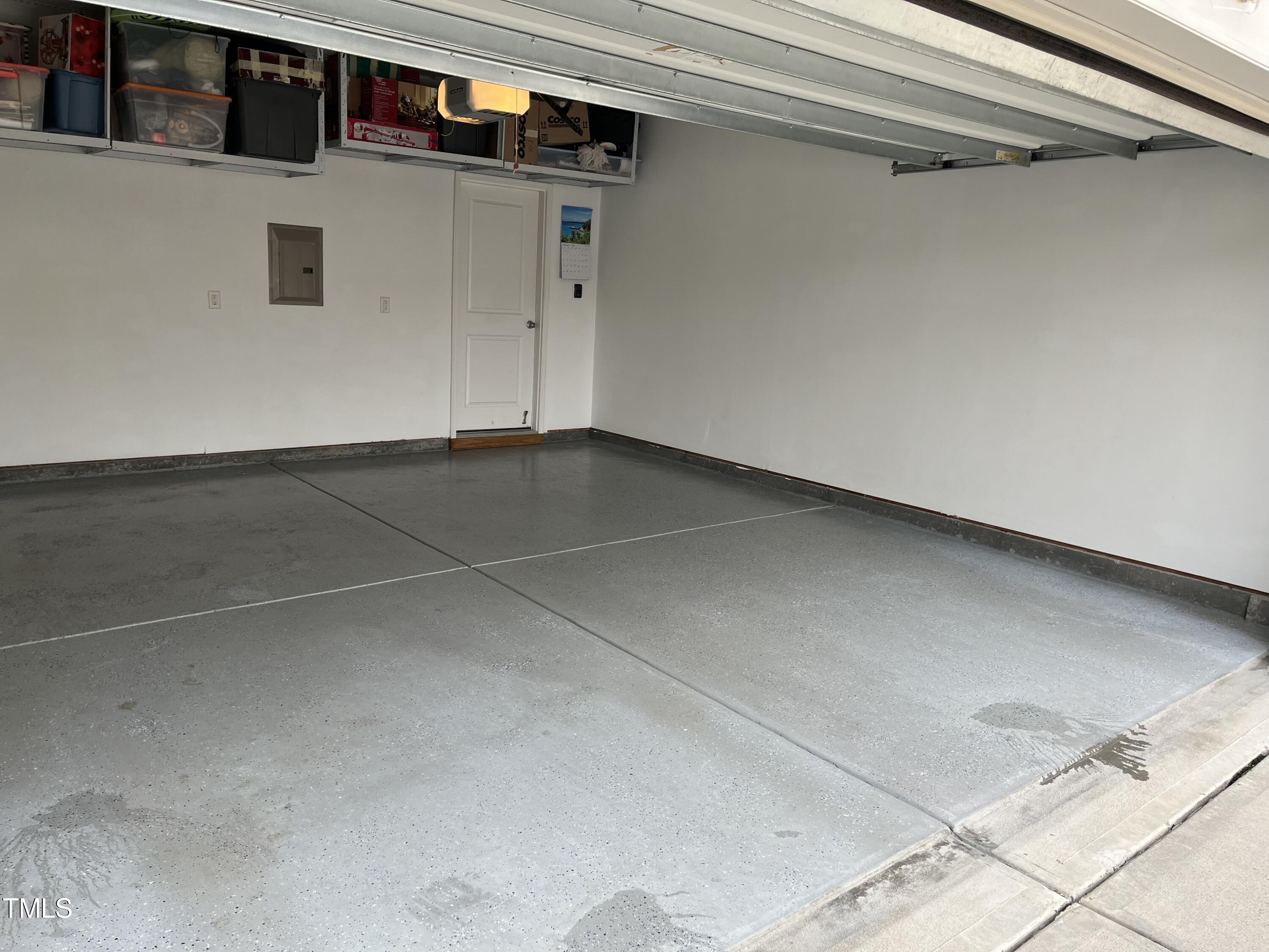 739 McRae Road Cary, NC 27519 - Photo 23 of 24 Garage with painted walls, overhead shelving and epoxy floors