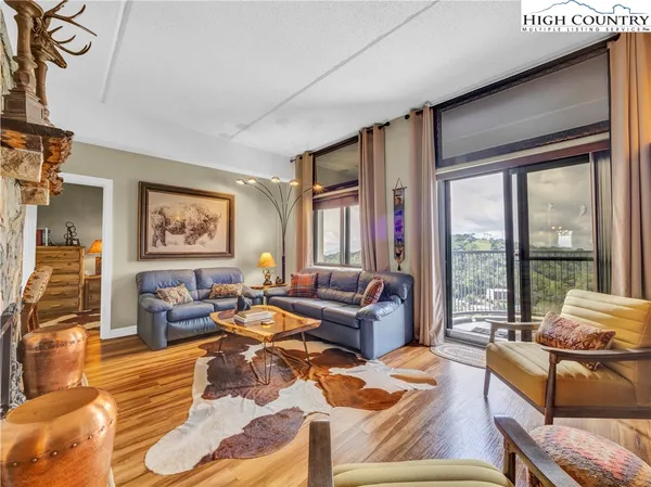a living room with furniture and a floor to ceiling window