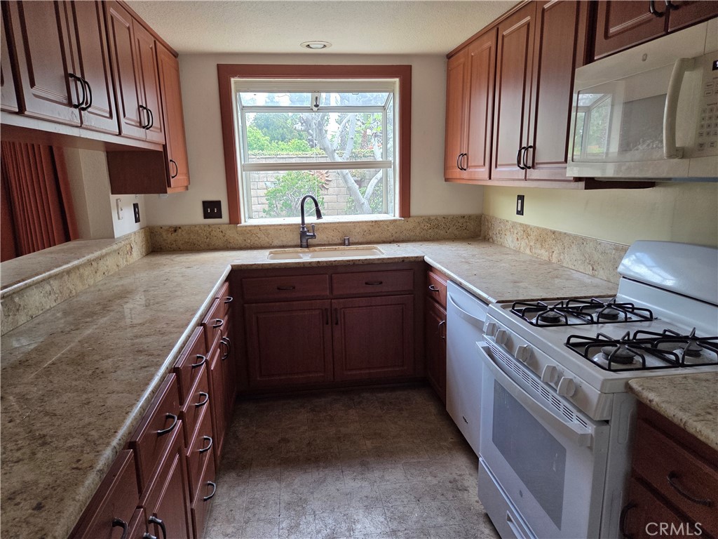 1330 Meadow Lane Duarte, CA 91010 - Photo 6 of 15 a kitchen with stainless steel appliances granite countertop a stove a sink and a microwave