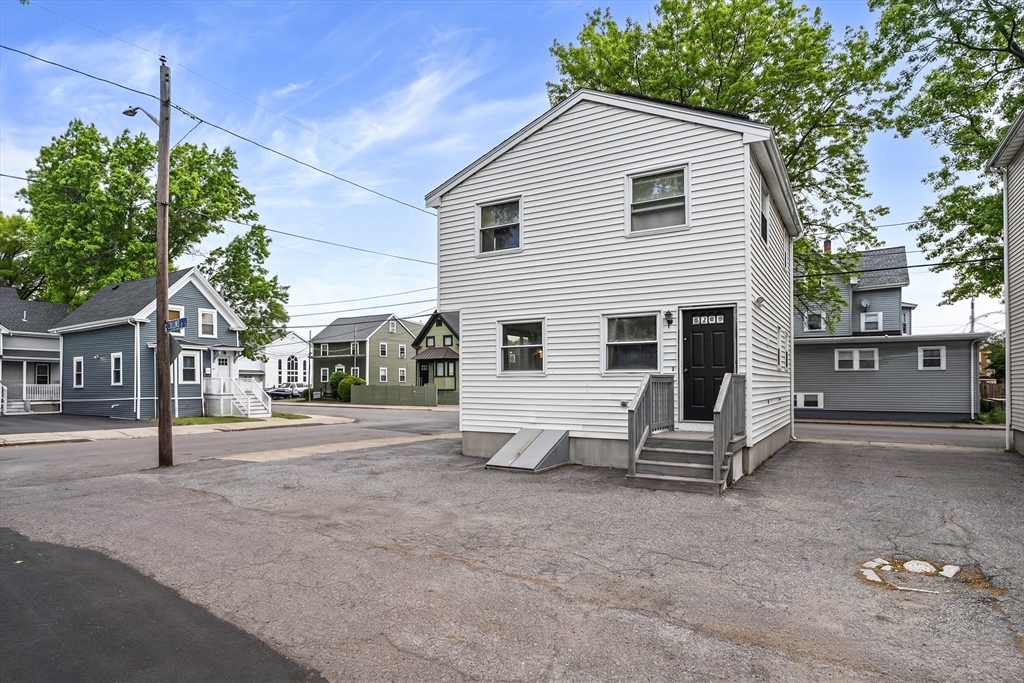 23 Logan Street Lynn, MA 01902 - Photo 4 of 27 a view of a house with backyard and a tree
