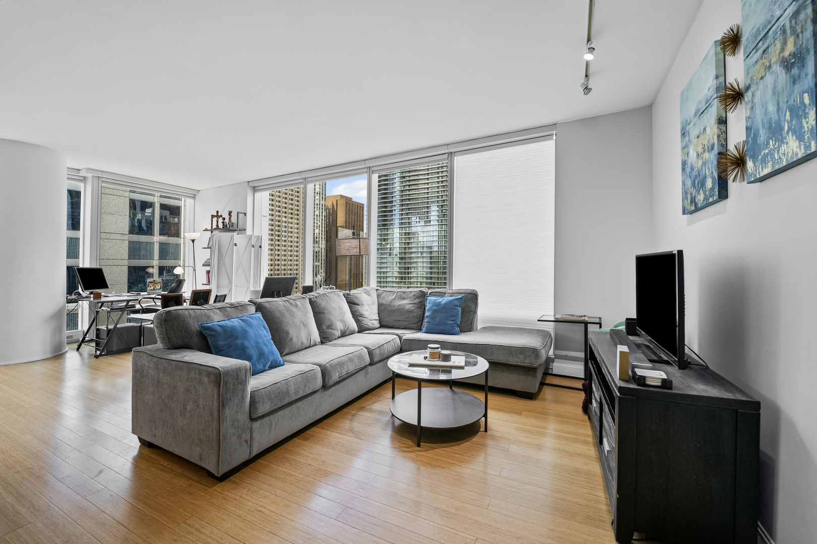 340 East Randolph Street, Unit 1206 Chicago, IL 60601 - Photo 2 of 46 a living room with furniture a flat screen tv and a large window