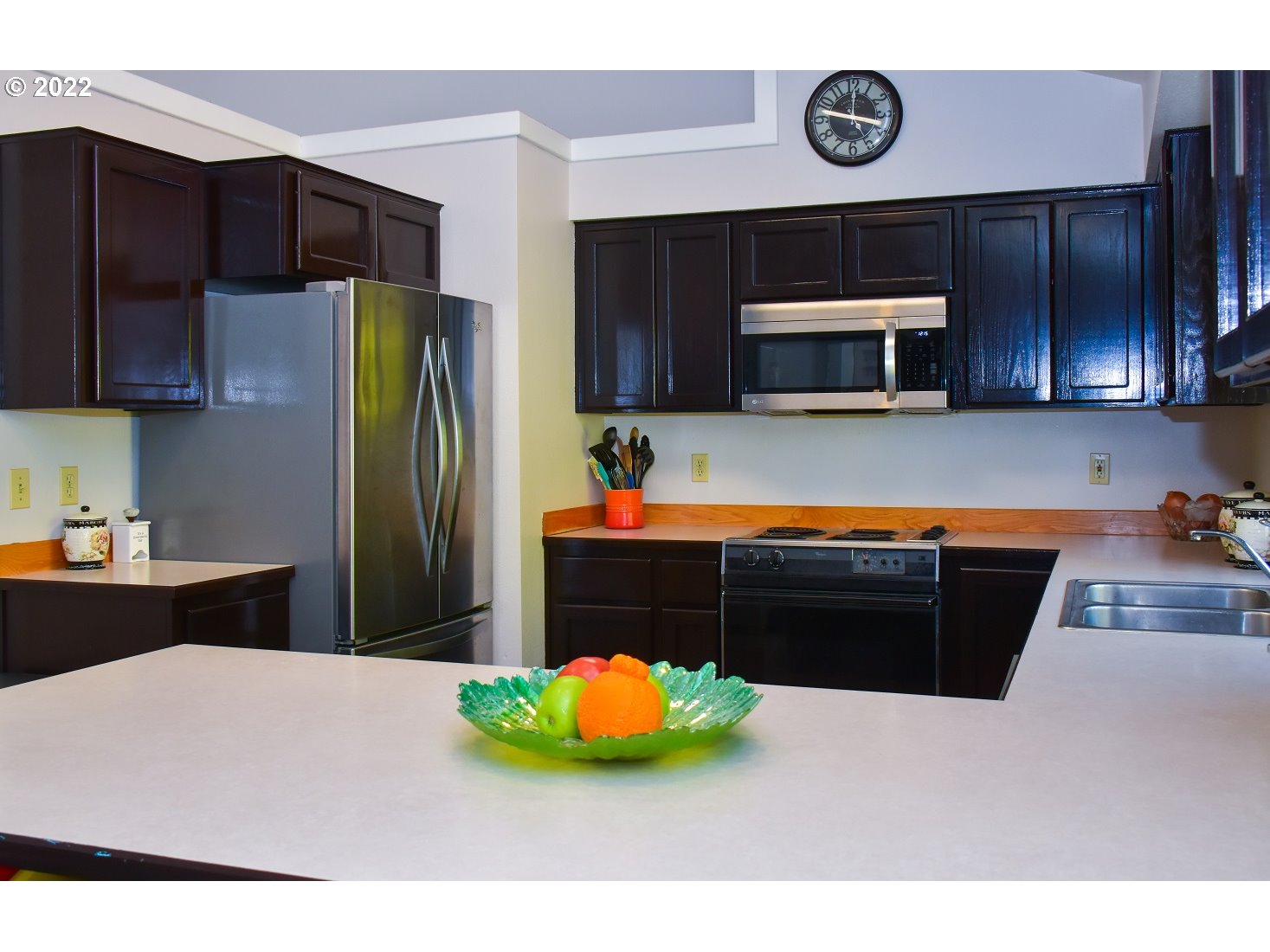 6806 D Court Springfield, OR 97478 - Photo 7 of 22 a kitchen with stainless steel appliances kitchen island granite countertop a refrigerator and a microwave