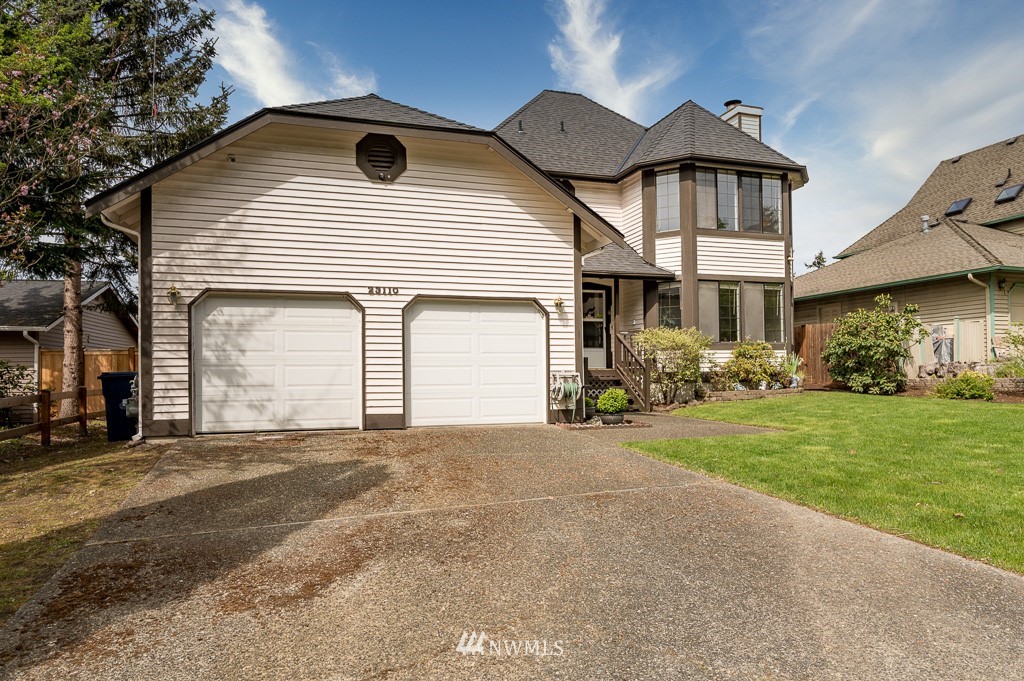 23110 13th Place West Bothell, WA 98021 - Photo 2 of 30 a front view of a house with a yard and garage