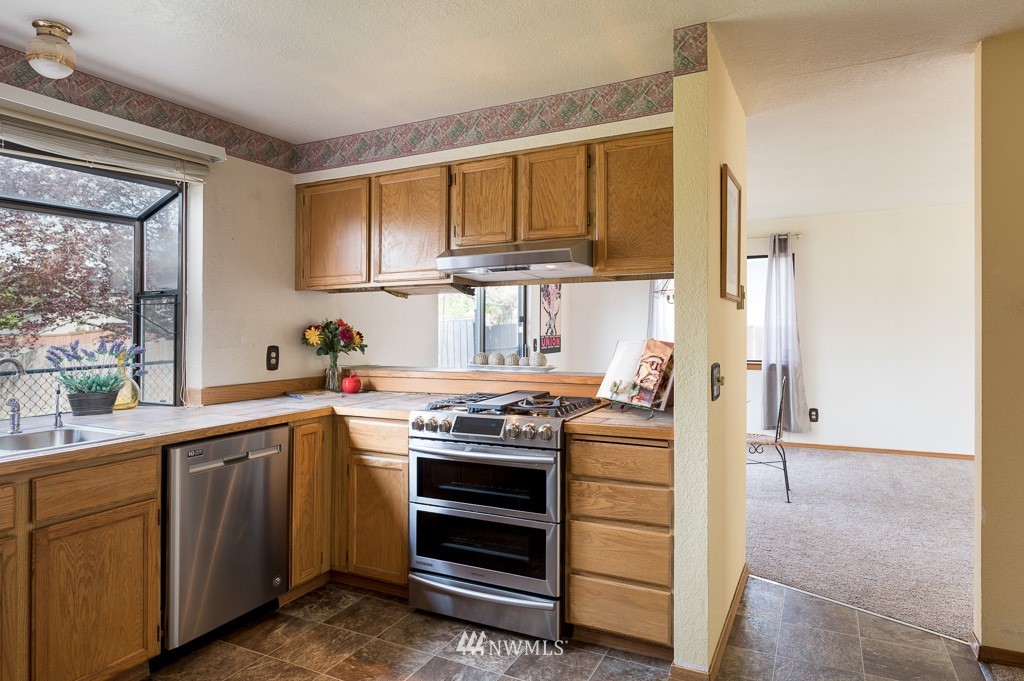 23110 13th Place West Bothell, WA 98021 - Photo 11 of 30 a kitchen with a stove and a sink