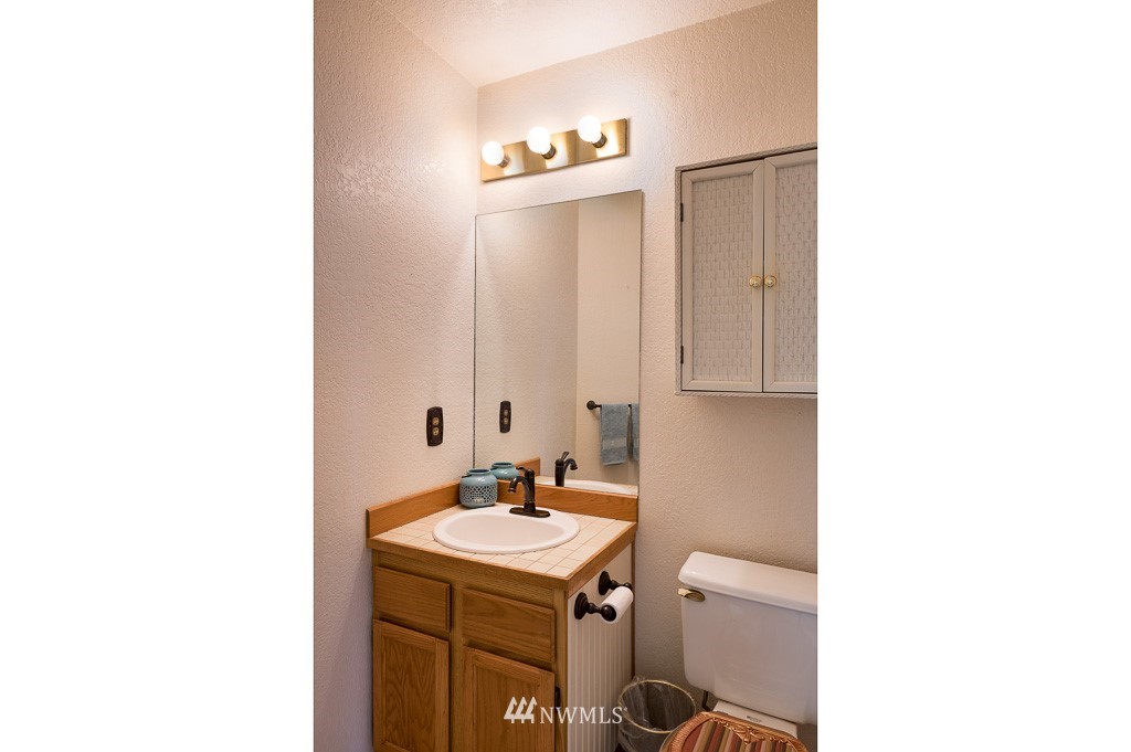 23110 13th Place West Bothell, WA 98021 - Photo 13 of 30 a bathroom with a sink and a mirror