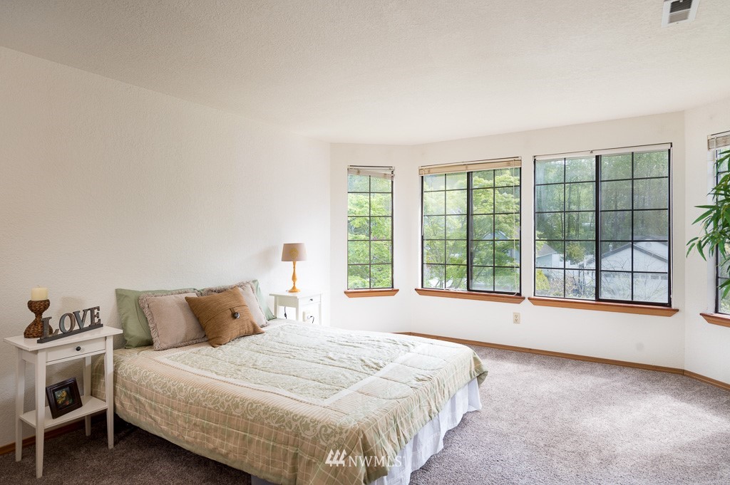 23110 13th Place West Bothell, WA 98021 - Photo 18 of 30 a spacious bedroom with a bed and a large window