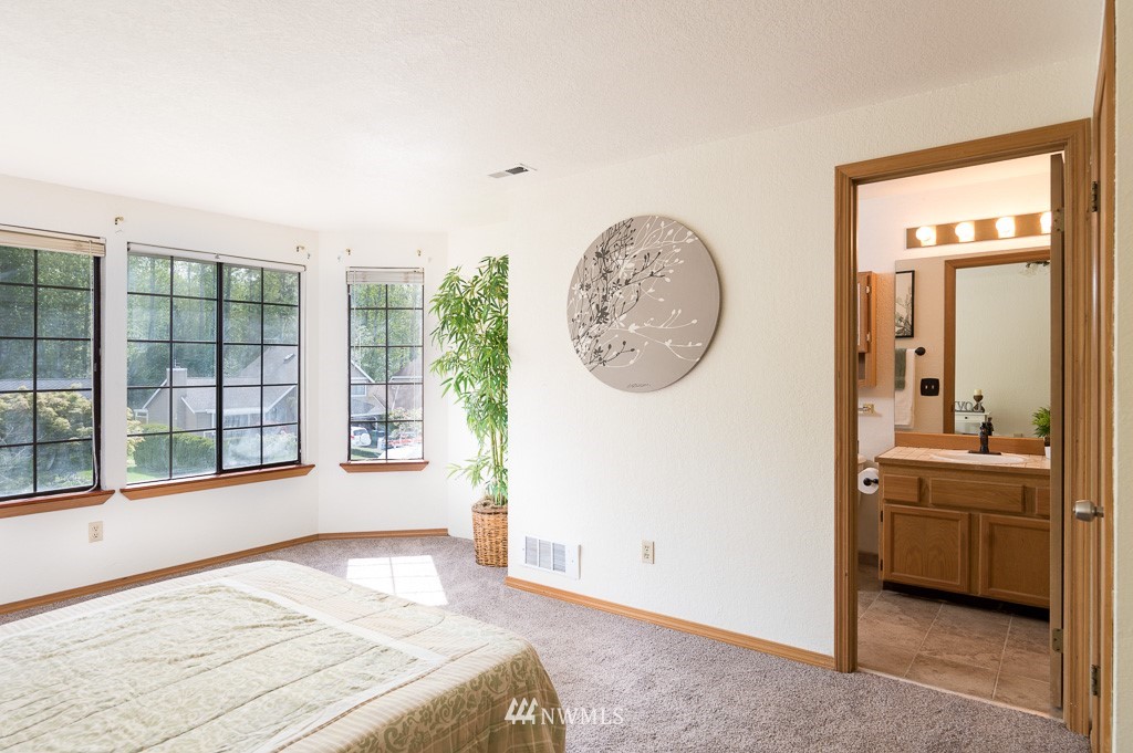 23110 13th Place West Bothell, WA 98021 - Photo 19 of 30 a bedroom with a large bed and a large window