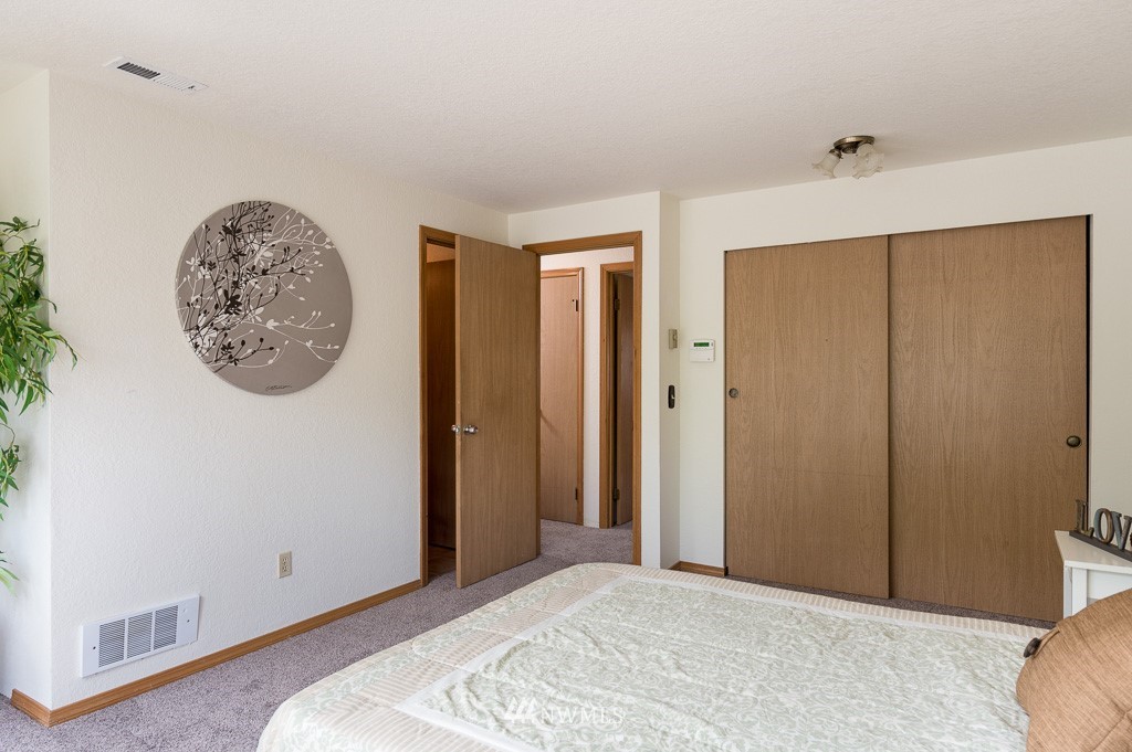 23110 13th Place West Bothell, WA 98021 - Photo 20 of 30 a bedroom with a large bed and a window