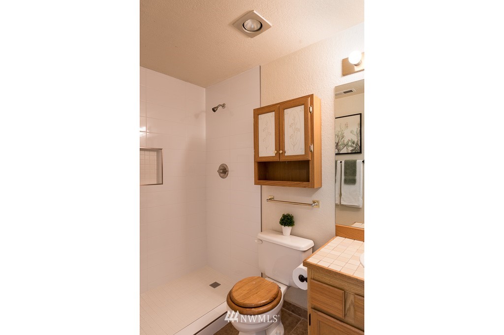 23110 13th Place West Bothell, WA 98021 - Photo 21 of 30 a bathroom with a toilet a sink and a mirror