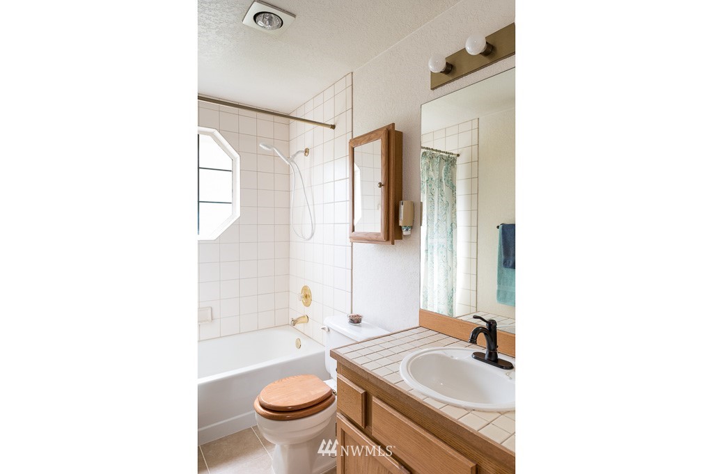 23110 13th Place West Bothell, WA 98021 - Photo 24 of 30 a bathroom with a sink toilet and shower