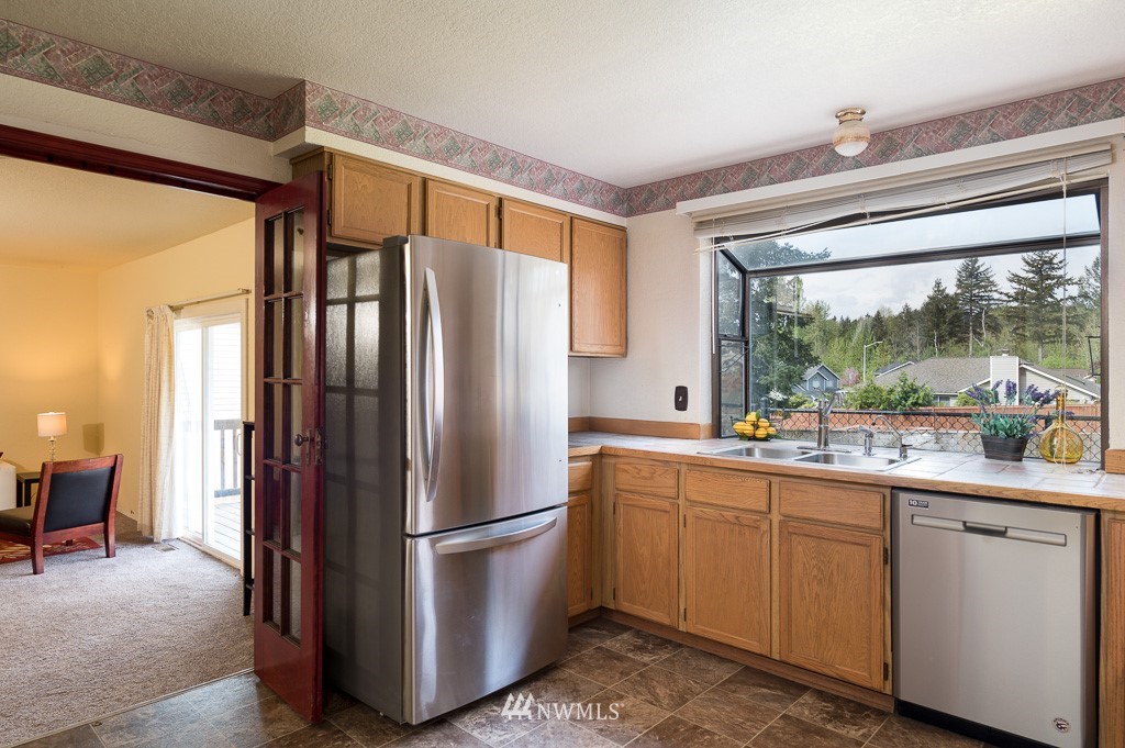 23110 13th Place West Bothell, WA 98021 - Photo 10 of 30 a kitchen with a refrigerator and countertop