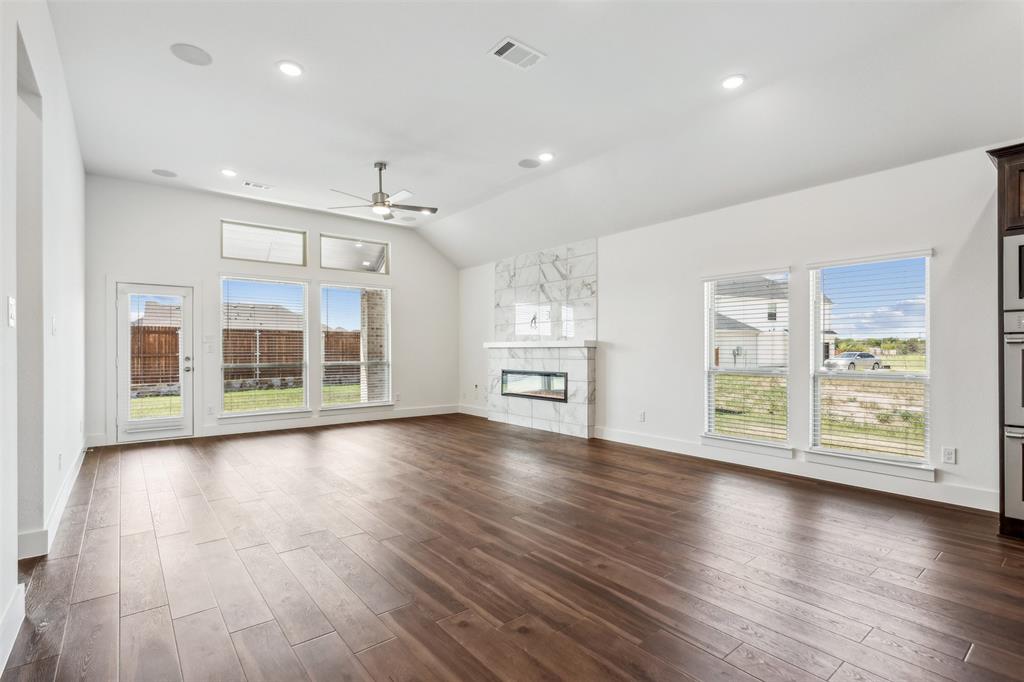 2540 Baypoint Drive Grand Prairie, TX 75054 - Photo 12 of 34 a view of an empty room with a window and wooden floor