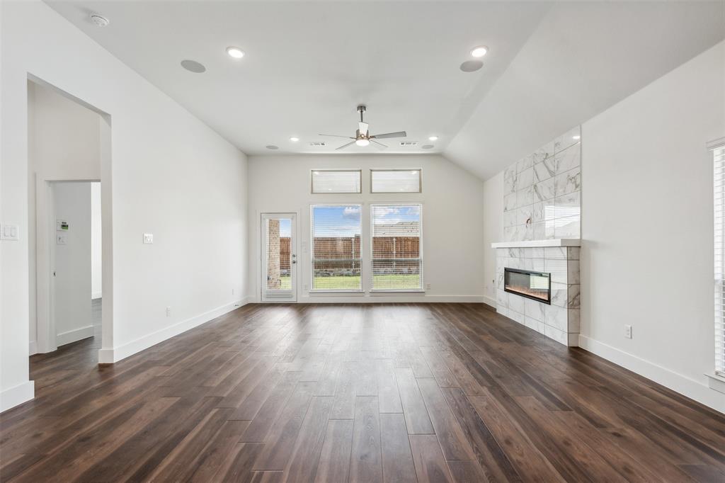 2540 Baypoint Drive Grand Prairie, TX 75054 - Photo 13 of 34 an empty room with wooden floor and windows