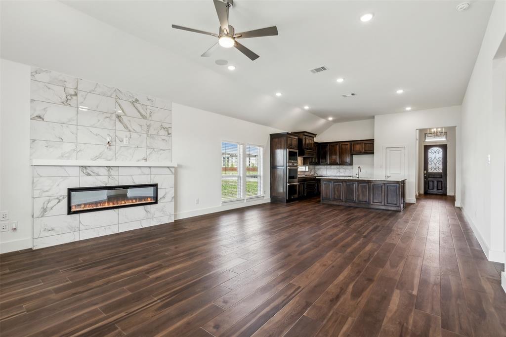 2540 Baypoint Drive Grand Prairie, TX 75054 - Photo 14 of 34 an empty room with wooden floor kitchen view and a kitchen