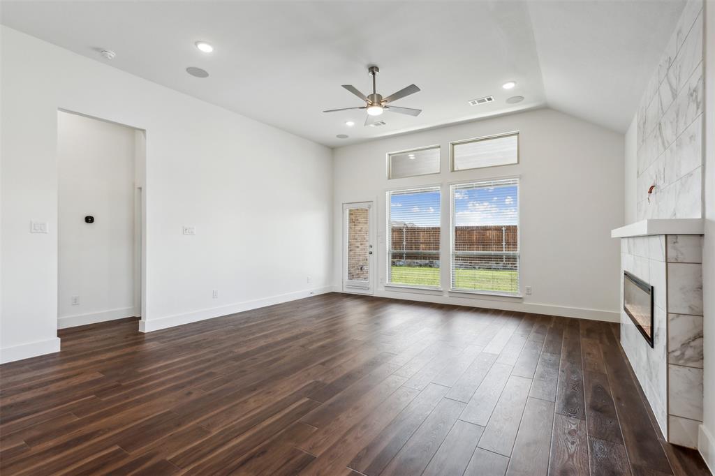 2540 Baypoint Drive Grand Prairie, TX 75054 - Photo 16 of 34 a view of a livingroom with wooden floor a ceiling fan and windows