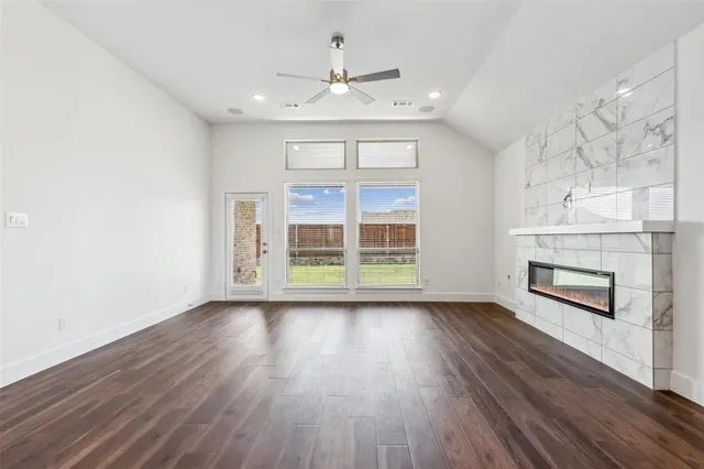 wooden floor in an empty room with a fireplace