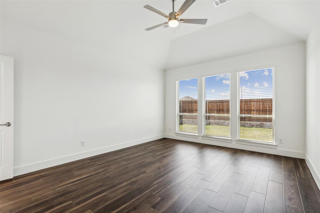 2540 Baypoint Drive Grand Prairie, TX 75054 - Photo 18 of 34 an empty room with wooden floor and windows