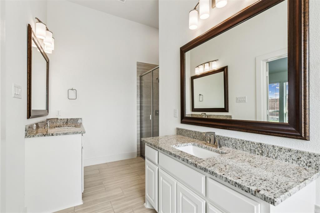 2540 Baypoint Drive Grand Prairie, TX 75054 - Photo 20 of 34 a bathroom with a sink and a mirror