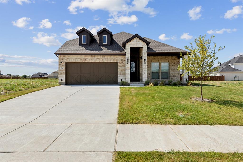 2540 Baypoint Drive Grand Prairie, TX 75054 - Photo 2 of 34 a front view of a house with a yard and garage