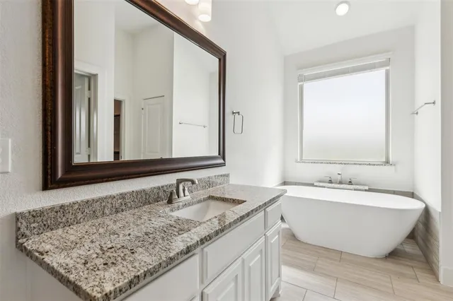 a bathroom with a bathtub and a sink