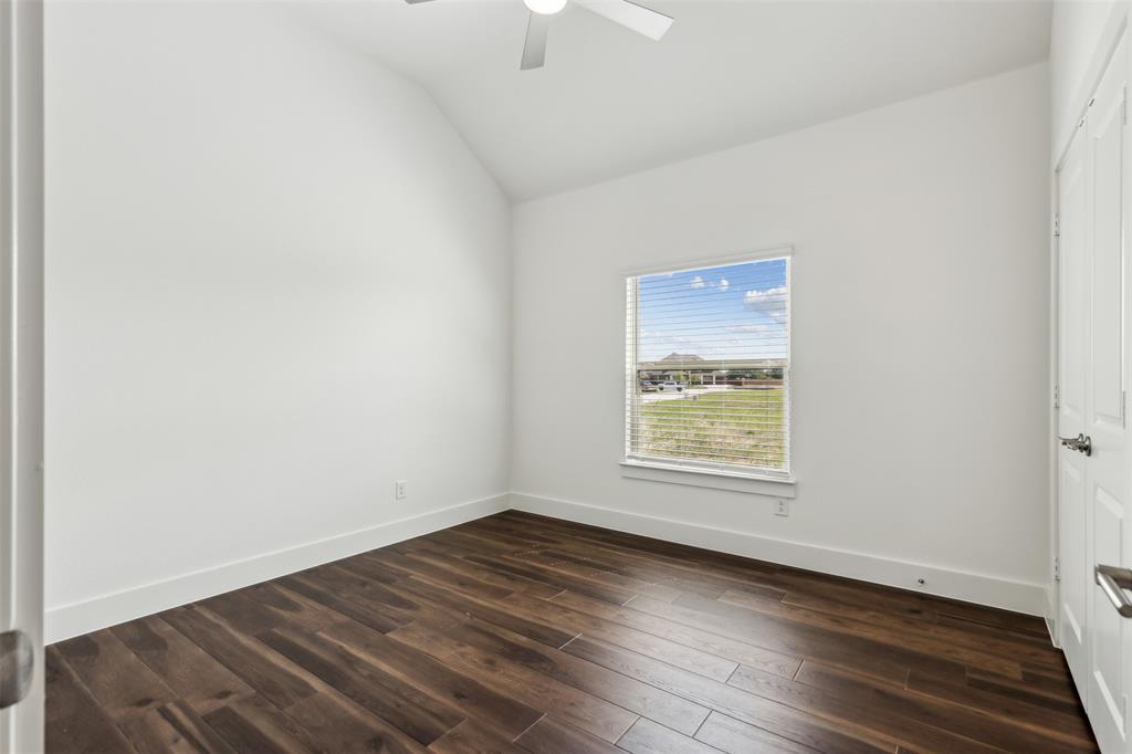 2540 Baypoint Drive Grand Prairie, TX 75054 - Photo 26 of 34 an empty room with wooden floor and windows