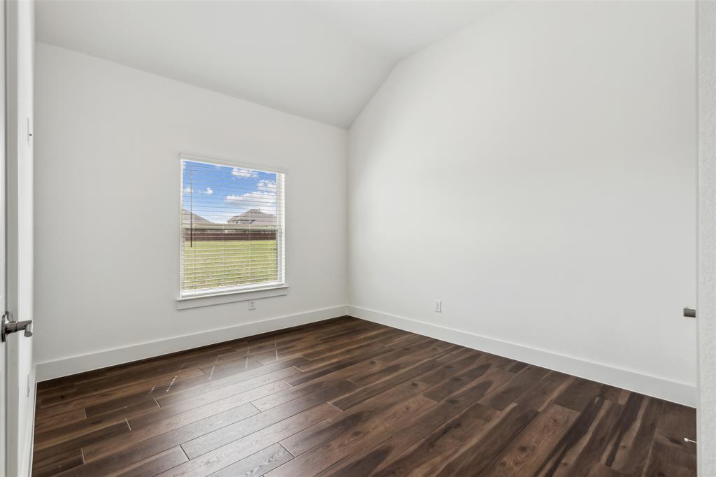 2540 Baypoint Drive Grand Prairie, TX 75054 - Photo 27 of 34 an empty room with wooden floor and windows