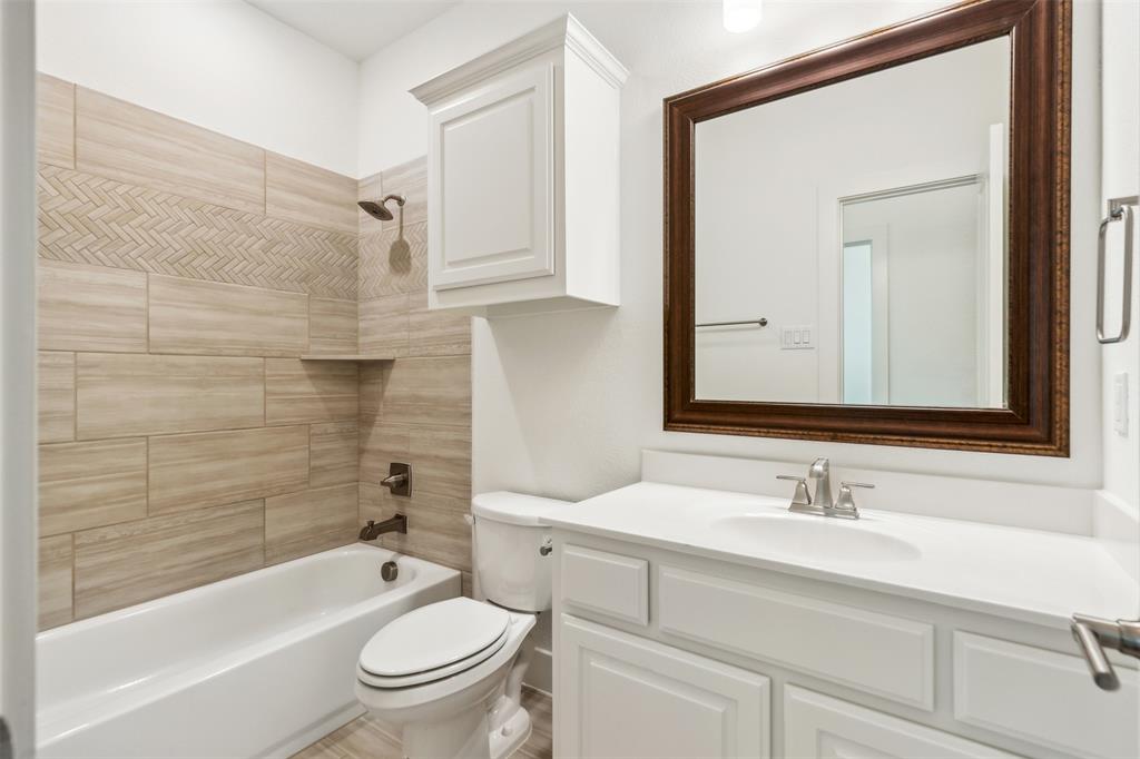 2540 Baypoint Drive Grand Prairie, TX 75054 - Photo 28 of 34 a bathroom with a sink a toilet and a bathtub