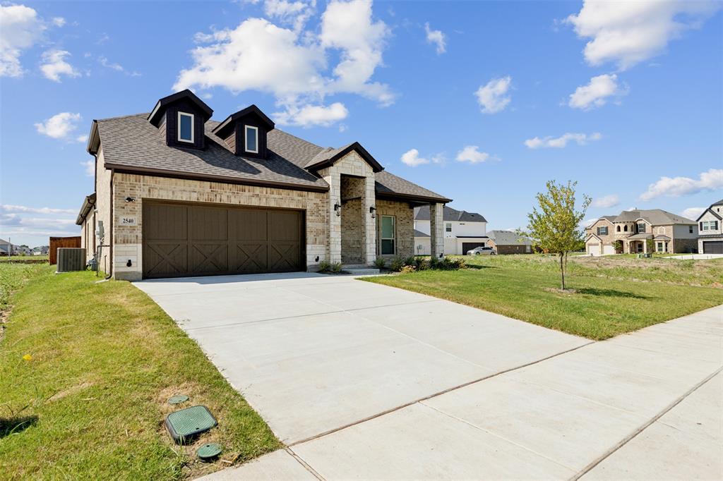 2540 Baypoint Drive Grand Prairie, TX 75054 - Photo 5 of 34 a front view of a house with a yard