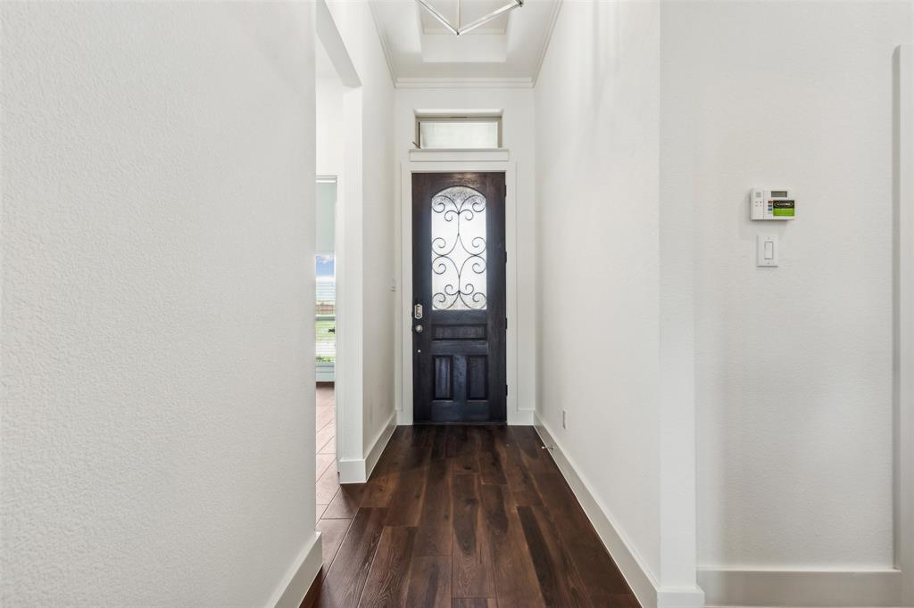 2540 Baypoint Drive Grand Prairie, TX 75054 - Photo 7 of 34 a view of a hallway with wooden floor