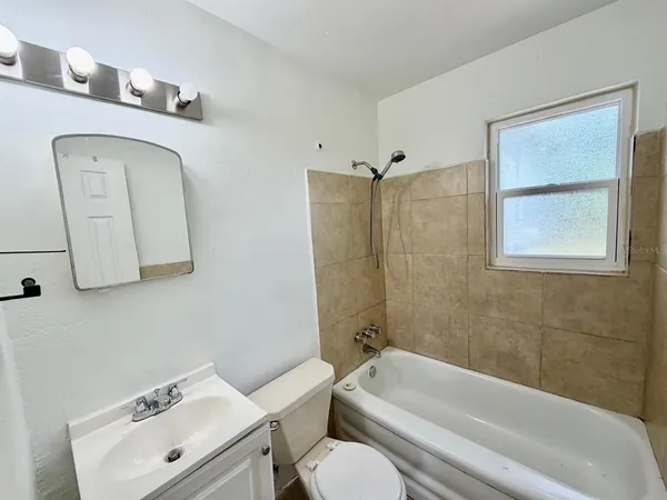 a bathroom with a toilet sink and shower