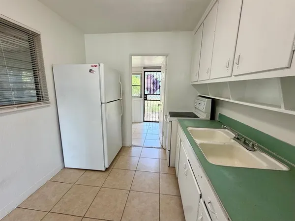a kitchen with a sink a stove and refrigerator
