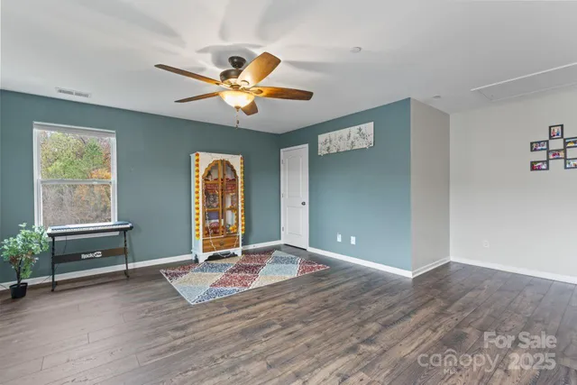 a view of a livingroom with a ceiling fan and window