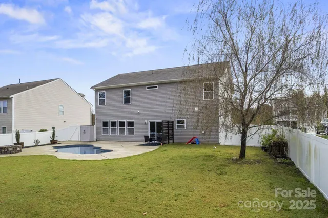 a view of a house with swimming pool and sitting area