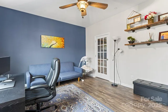 a workspace with furniture and ceiling fan