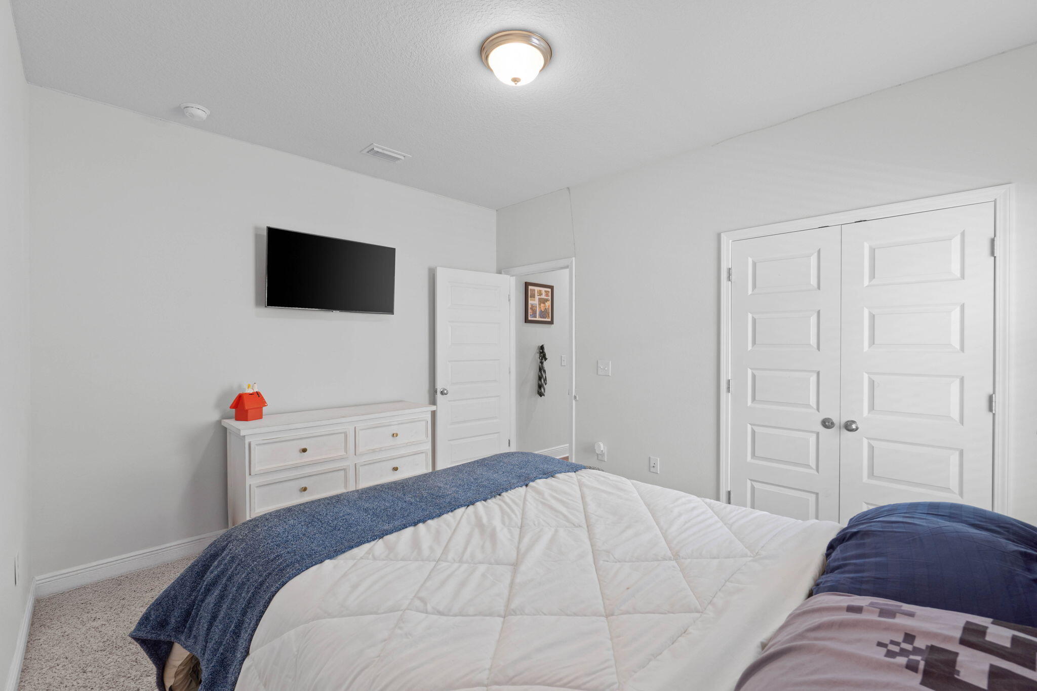 371 Lightning Bug Lane Freeport, FL 32439 - Photo 16 of 56 a bedroom with a bed and a flat screen tv